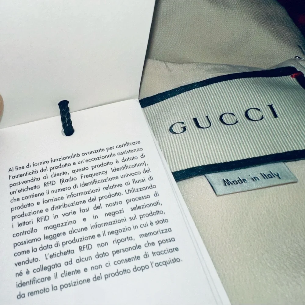 Gucci Red, Crème and Black Asymmetrical Dress with Gucci ivory dress cover. - Picture 13 of 15